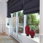 Large window with black Roman blinds