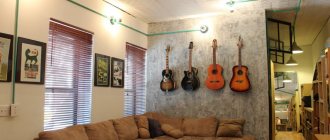 Guitars on a concrete wall in a man&#39;s apartment