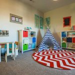 Play hut on a rug with a bright print