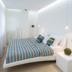 Interior of a narrow bedroom in white