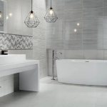 The combination of white and gray on the walls of a minimalist bathroom