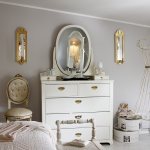 Mirror on a chest of drawers in a classic bedroom